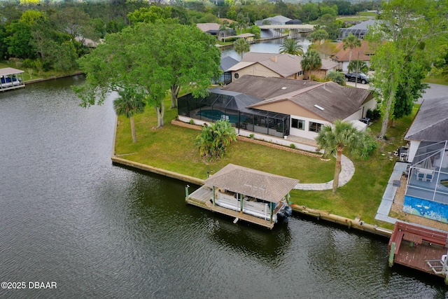 birds eye view of property with a water view and a residential view