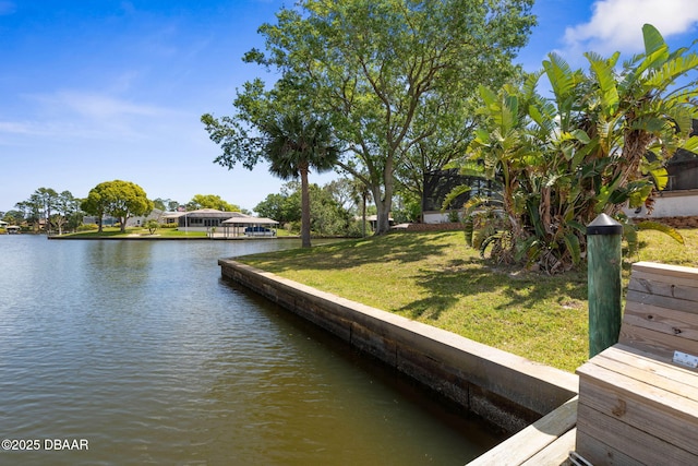 view of dock featuring a yard and a water view