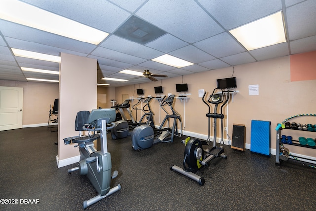 gym with a paneled ceiling and ceiling fan