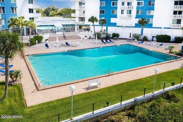 view of swimming pool featuring a patio area