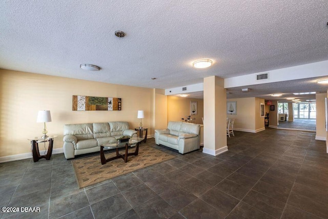 tiled living room featuring a textured ceiling