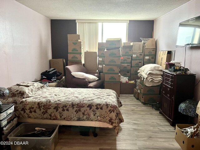 935 N Halifax Ave Unit 907, Daytona Beach, FL 32118 - bedroom featuring light wood-style flooring and a textured ceiling