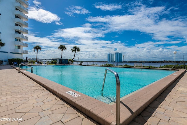 view of pool with a water view