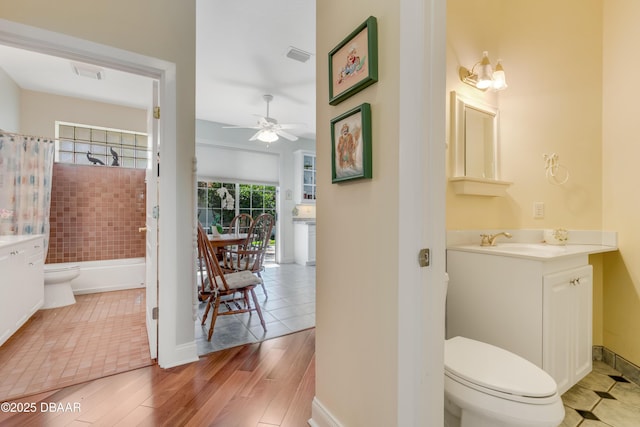203 Prestwick Dr, New Smyrna Beach, FL 32168 - full bath with toilet, vanity, ceiling fan, shower / tub combo with curtain, and baseboards