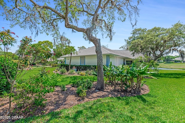 203 Prestwick Dr, New Smyrna Beach, FL 32168 - view of side of property featuring a lawn and stucco siding