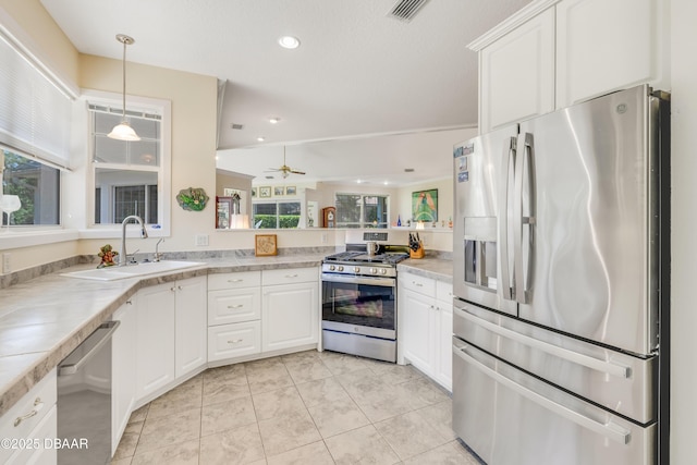 203 Prestwick Dr, New Smyrna Beach, FL 32168 - kitchen featuring appliances with stainless steel finishes, a sink, light countertops, white cabinetry, and recessed lighting