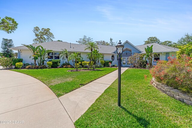 203 Prestwick Dr, New Smyrna Beach, FL 32168 - single story home featuring french doors, a front yard, and stucco siding
