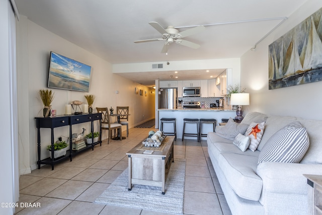 living room with light tile patterned flooring and ceiling fan