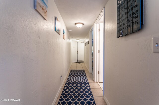 hallway with light tile patterned floors