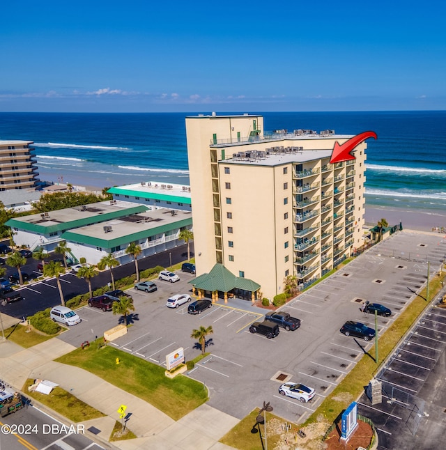 drone / aerial view featuring a beach view and a water view