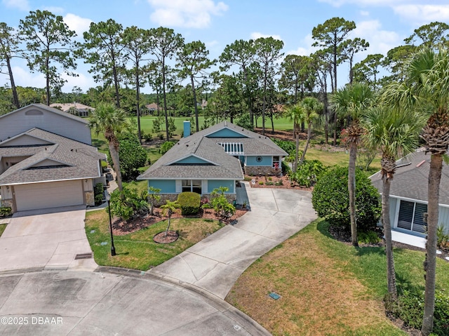 view of front of house featuring concrete driveway and a front yard