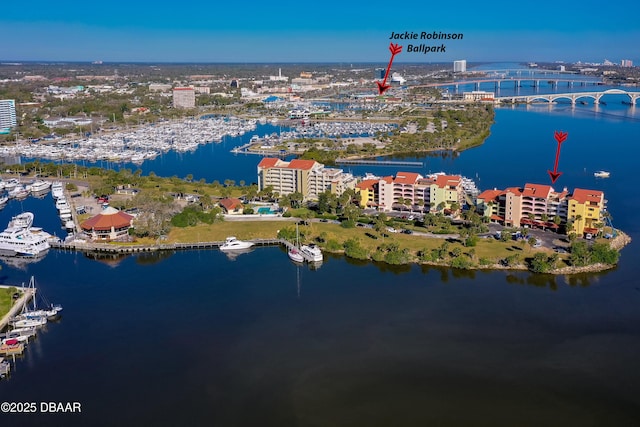 birds eye view of property with a view of city and a water view