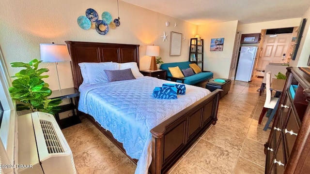 bedroom featuring white refrigerator