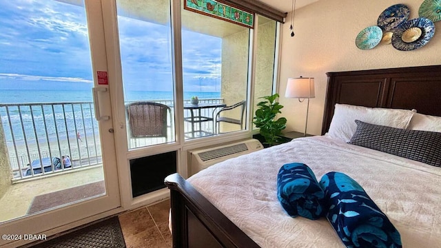 bedroom with a water view and a wall mounted AC