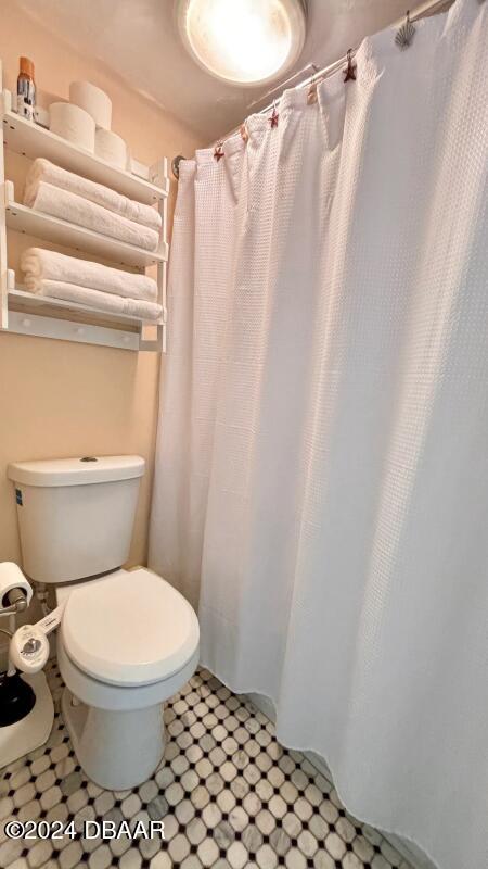 bathroom featuring tile patterned floors and toilet