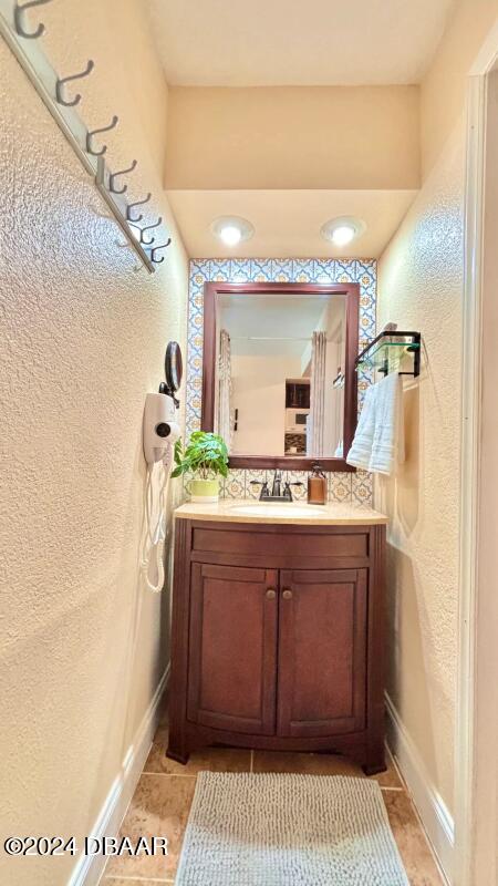 bathroom with tile patterned floors and vanity