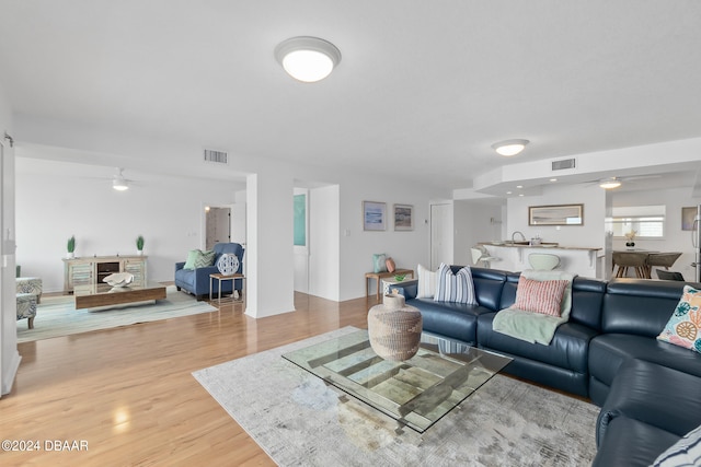 living room featuring hardwood / wood-style flooring and ceiling fan