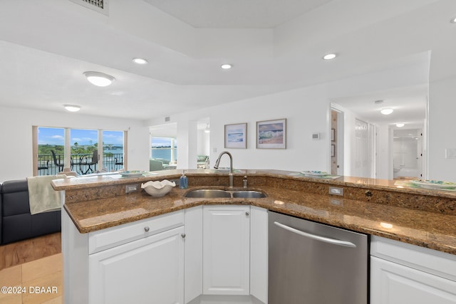 kitchen featuring dark stone counters, sink, white cabinets, and stainless steel dishwasher