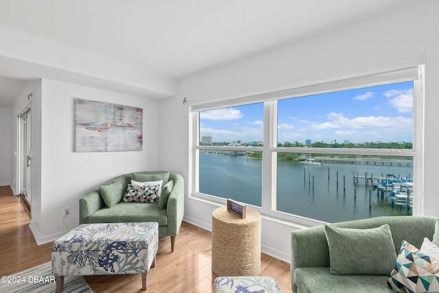 sitting room featuring hardwood / wood-style floors and a water view