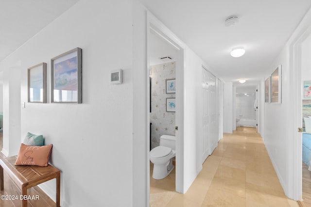 hall with light tile patterned floors