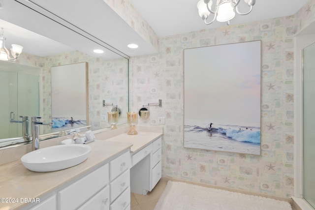 bathroom featuring tile patterned flooring, a notable chandelier, walk in shower, and vanity