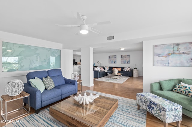 living room featuring ceiling fan and wood-type flooring