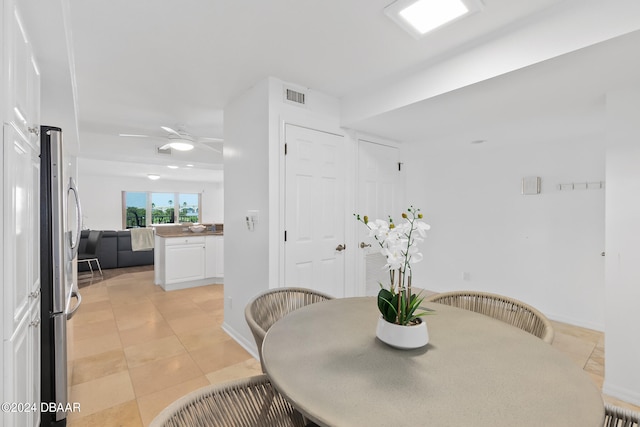 dining room featuring light tile patterned floors and ceiling fan