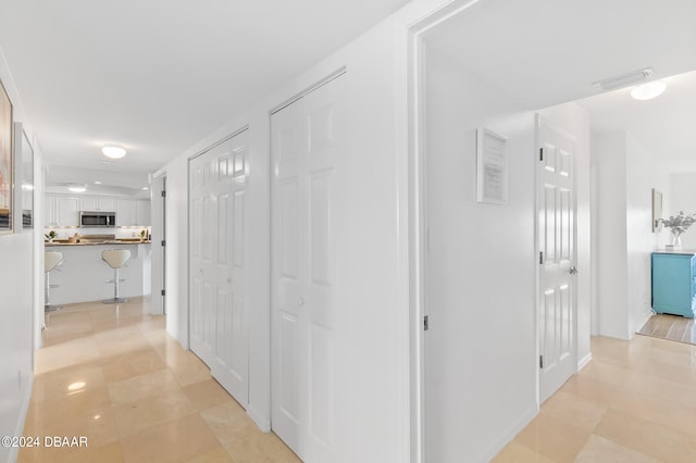 hall with light tile patterned floors