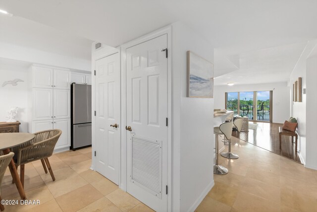 hall with light tile patterned floors