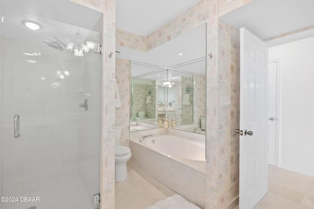 bathroom featuring tile patterned flooring, shower with separate bathtub, and toilet