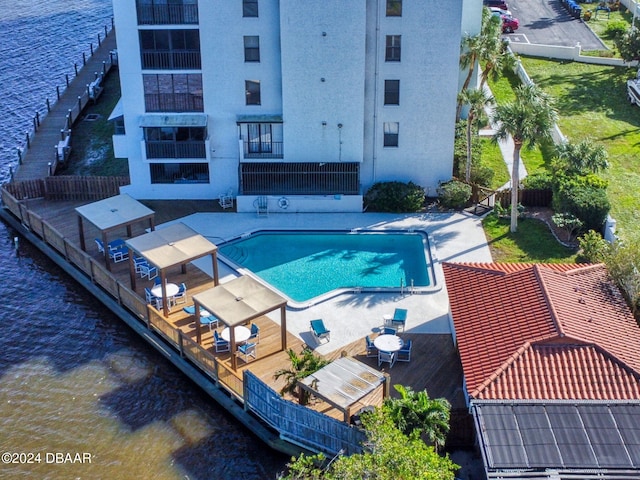 view of swimming pool with a deck with water view and a patio