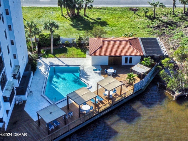 view of swimming pool featuring a deck and a patio