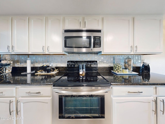 kitchen featuring white cabinets, stainless steel appliances, and tasteful backsplash