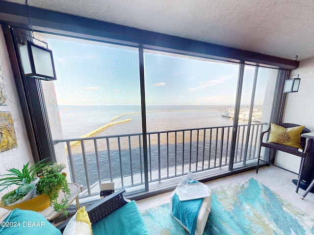 sunroom / solarium featuring a water view