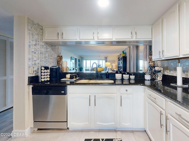 kitchen featuring dishwasher, white cabinetry, and sink