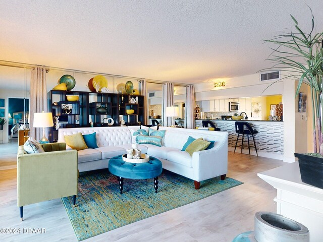 living room with hardwood / wood-style floors and a textured ceiling