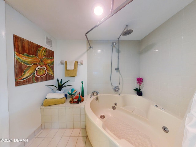 bathroom with tile patterned flooring and tiled shower / bath combo