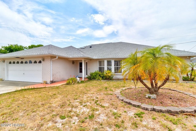 ranch-style home with a garage and a front lawn