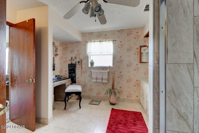 bathroom with a textured ceiling and ceiling fan