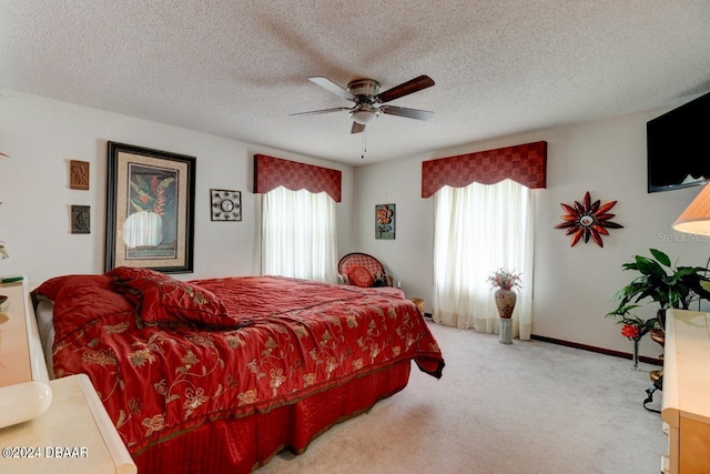 carpeted bedroom featuring a textured ceiling and ceiling fan