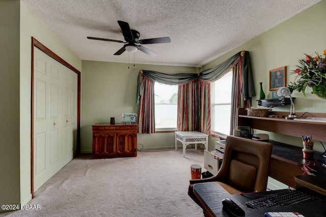 living area featuring a textured ceiling, light colored carpet, and ceiling fan