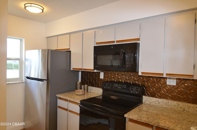 kitchen with white cabinetry, black appliances, tasteful backsplash, and light stone countertops