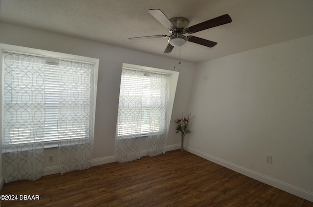 empty room with dark hardwood / wood-style flooring and ceiling fan