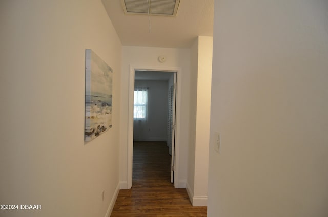 corridor with dark hardwood / wood-style flooring