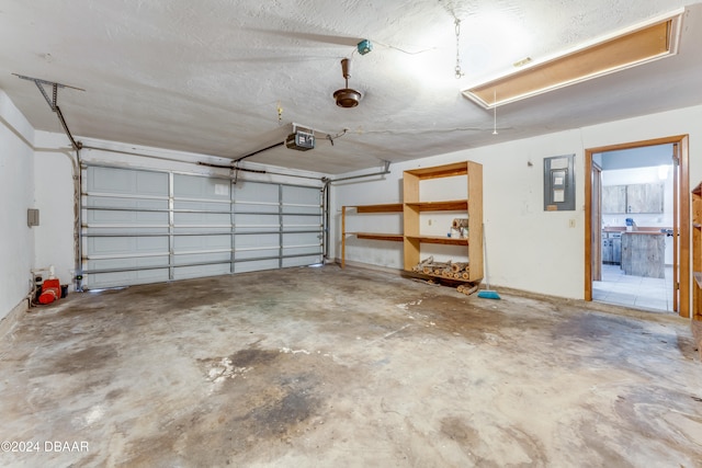 garage featuring electric panel and a garage door opener