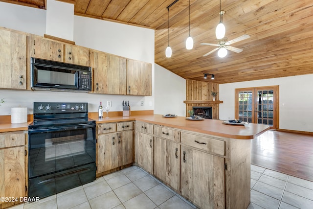 kitchen featuring black appliances, pendant lighting, kitchen peninsula, and vaulted ceiling