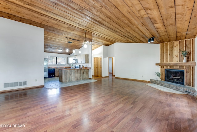 unfurnished living room featuring a fireplace, hardwood / wood-style flooring, vaulted ceiling, and wooden ceiling