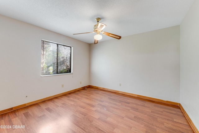 500 Sandy Oaks Blvd, Ormond Beach, FL 32174 - empty room with light wood finished floors, a ceiling fan, baseboards, and a textured ceiling