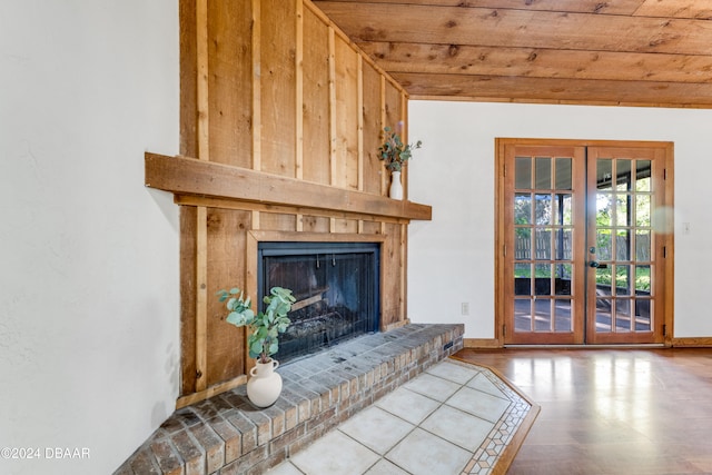 living room featuring a fireplace, wood ceiling, and french doors