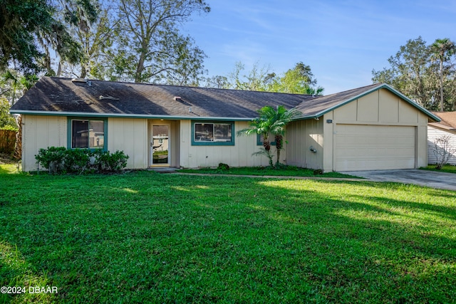 ranch-style house with a garage and a front yard